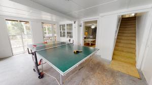 a ping pong table in the middle of a room at Family Time Lower by Tybee Vacation Rentals in Tybee Island