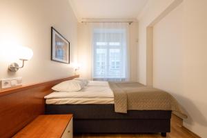 Postel nebo postele na pokoji v ubytování Old Town - Hall Square Apartment