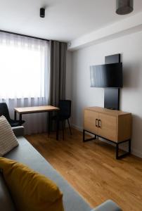 a living room with a couch and a table at Apartamenty Loftove in Wadowice