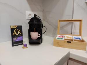a coffee maker sitting on a counter next to a box at La casetta di Emilia in Corfu Town