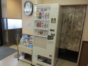 a vending machine in a room with a clock at Hotel Heart INN Hakodate - Vacation STAY 56676v in Hakodate