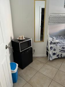 a small room with a microwave and a bunk bed at B2 Best Value on Private Bedroom with Private Bathroom in Little Havana, Miami in Miami
