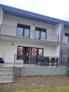 un edificio blanco con balcón con mesas y sillas en IONE & B Residance, en Sibiu