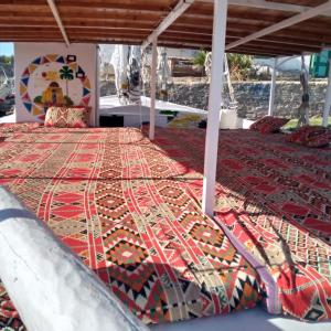 a bed with a colorful rug on the floor at ABU Guest House in Aswan