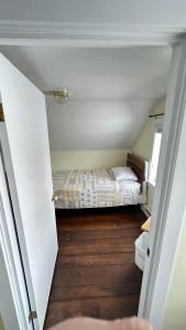 a small bedroom with a bed in a room at Victoria Cottage in Twillingate
