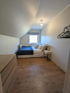 a bedroom with a bed in the corner of a room at Countryside experience in a Cozy Loft Near Bergen in Frekhaug