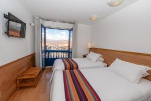 Postel nebo postele na pokoji v ubytování Hotel Plaza de Armas Cusco