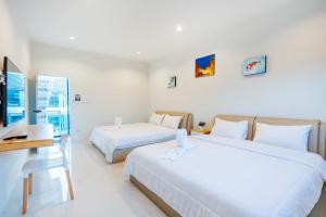 En eller flere senge i et værelse på P Henry&App2 Poolvilla Huahin + 39 billeder