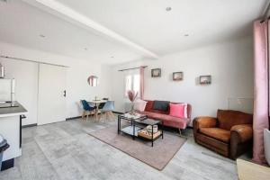 ein Wohnzimmer mit einem Sofa und einem Tisch in der Unterkunft Maison avec terrasse à quelques minutes de la place Morny in Deauville