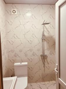 a bathroom with a white toilet and a sink at Old tbilisi in Tbilisi City