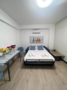 a bedroom with a bed and two tables with flowers at Lazarus Oasis in Larnaca
