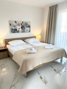 sypialnia z 2 łóżkami i ręcznikami w obiekcie Apartments Mare w mieście Punat