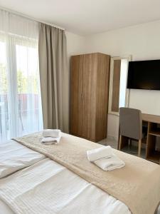 a bedroom with a bed with two towels on it at Apartments Mare in Punat