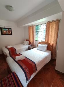 Postel nebo postele na pokoji v ubytování INTI WAYRA MACHUPICCHU