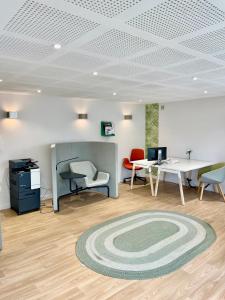 an office with a table and chairs and a rug at Chambre Confort - Douche Privative - Jardin - Parking Gratuit in Argenteuil