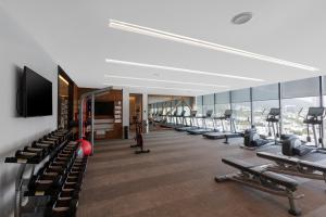 a gym with a row of treadmills and machines at Hilton Monterrey in Monterrey