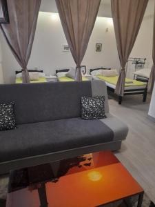 a living room with a couch and two beds at Dream INN Sarajevo in Sarajevo +34 photos