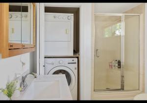a kitchen with a washing machine and a washer at Seaside Serenity, Your Pine Point Beach Paradise in Scarborough