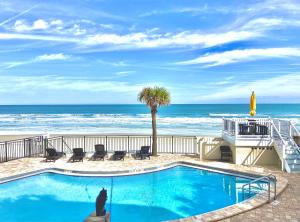 a swimming pool with a view of the beach at Organic Beach Retreat in Daytona Beach