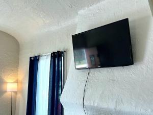 a flat screen tv hanging on a wall at Hollywood Gem 2 Bed Haven! in Los Angeles