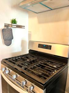 a stove top oven sitting in a kitchen at Hollywood Gem 2 Bed Haven! in Los Angeles