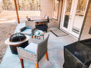 a patio with chairs and a grill and a table at Pet Friendly Rancher Brand New on 40 Acres in Leadville