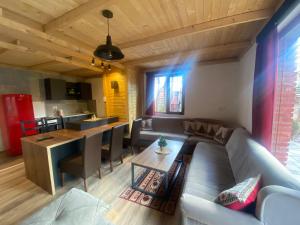 a living room with a couch and a table at STANET Forest Houses in Novoberdo +60 photos