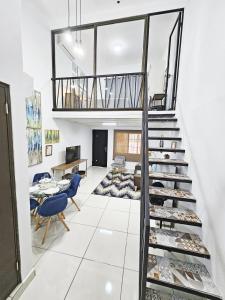 a room with a staircase with blue chairs at Loft Moderno y Tranquilo # 7 in Panama City
