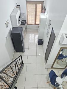 a kitchen with a staircase leading up to a living room at Loft Moderno y Tranquilo # 7 in Panama City