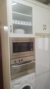 a kitchen with a microwave oven and a dishwasher at Cristeta2 in Medina de Pomar
