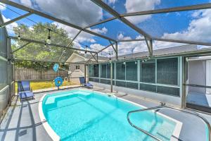 an indoor swimming pool with a glass ceiling at Day Trip to Disney and Beach Home with Saltwater Pool in Deltona