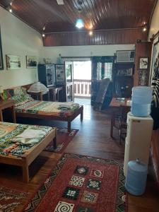a room with two beds and a table at Casa Trattoria Itaya in Iquitos