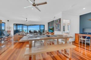 a dining room and living room with a table at Marlin Lodge in Tangalooma
