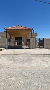 a building with a gate in the middle of a field at Laura's Stylish Room in Madaba
