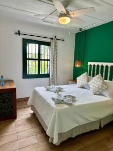 a bedroom with a large bed with a green wall at Selah hotel & coffee in Antigua Guatemala