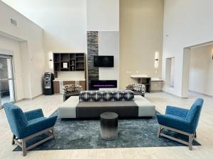 a living room with a couch and two chairs at La Quinta by Wyndham Allen at The Village in Allen