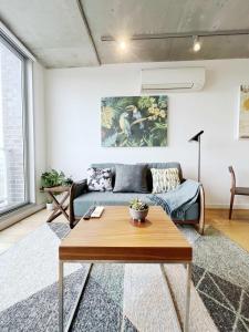 a living room with a couch and a table at Apartment on Regent in Melbourne