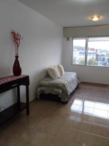 a bedroom with a bed with two pillows on it at Departamento centrico in Ushuaia