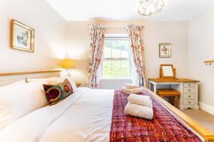een slaapkamer met een bed en een raam bij Dell Cottage in Ambleside