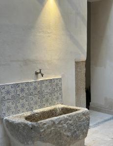 a large stone tub in a room with a sink at GREEN FRESH in Trapani