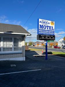 a sign for a motel in front of a house at Kowhai Motel Rotorua in Rotorua