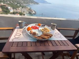 a tray of breakfast food on a table on a balcony at Royal View in Mani in Kokkala +23 photos