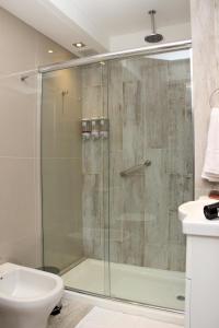 a bathroom with a shower and a toilet and a sink at In House BA - College in Buenos Aires