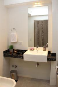 a bathroom with a white sink and a mirror at In House BA - College in Buenos Aires