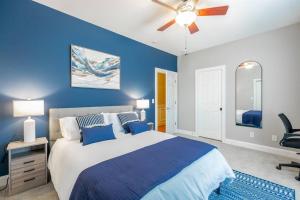 a blue bedroom with a bed and a ceiling fan at Pickleball - Pool - Hot Tub - Gym - BBQ in Cenchat +67 photos