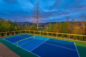 a tennis court on top of a house at Pickleball - Pool - Hot Tub - Gym - BBQ in Cenchat