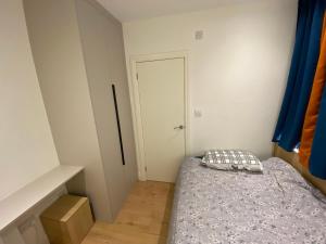 a small bedroom with a bed and a door at Not very quiet but Best location in London