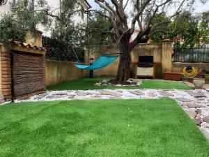 a yard with a hammock and a tree at Casa L ulivo in Santa Maria Navarrese