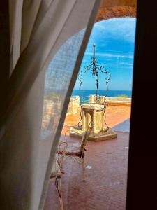 a view of a table and a chair from a window at Villa Incina - Sea House in Polignano a Mare