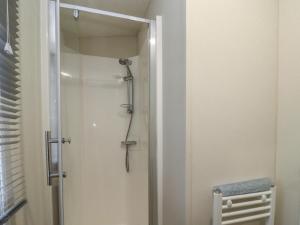 a shower with a glass door in a bathroom at Cotswold Cwtch in Evesham +13 photos